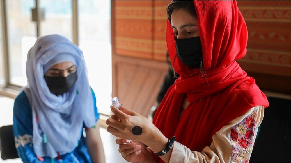 A young girl receiving HPV vaccination as part of a cervical cancer prevention campaign.