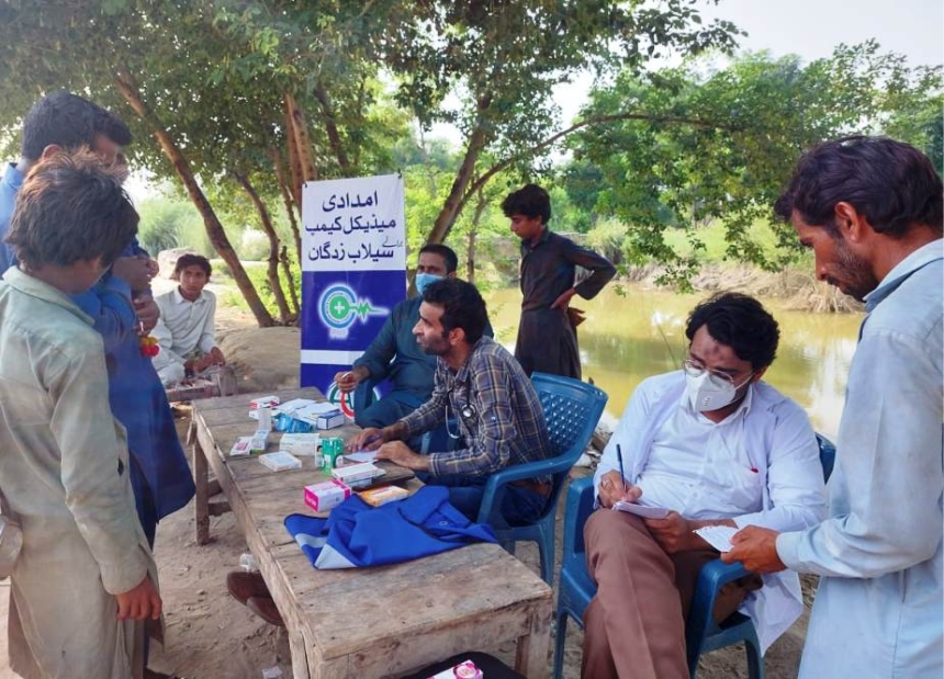 Medical relief camp in rural Pakistan after natural disaster, as cholera outbreaks remain a grave threat following disasters.