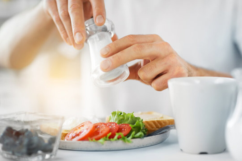 A representative image of a man holding table salt.