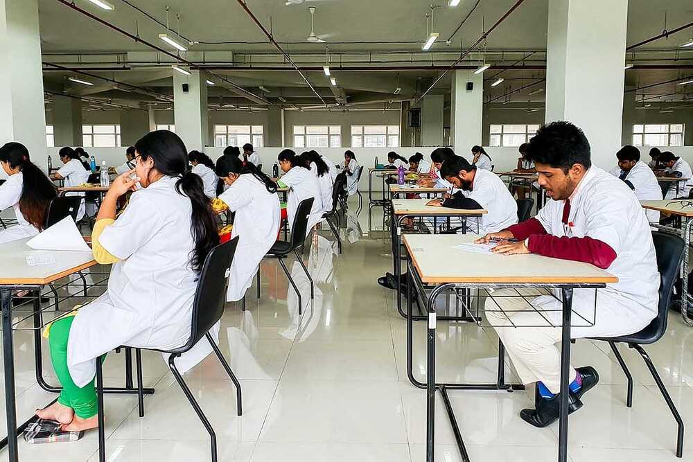 Medical students sitting in an examination hall.
