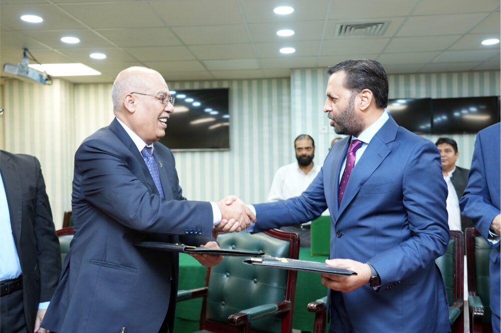 Pakistani health minister Syed Mustafa Kamal shakes hands with Palestinian ambassador Dr. Zuhair Zaid after signing health cooperation MoU in Islamabad