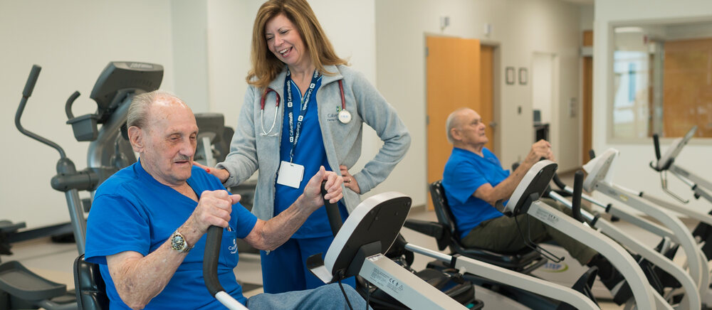 A heart patient undergoing cardiac rehabilitation guided by a physiotherapist
