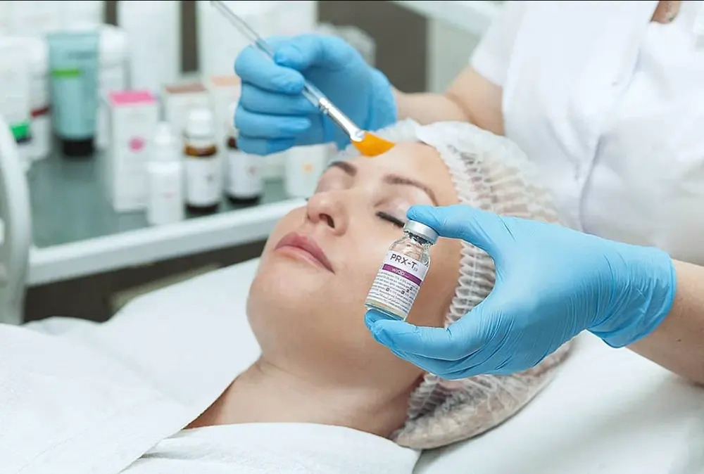 A woman receiving a chemical peel treatment for smoother, glowing, and rejuvenated skin at a dermatology clinic
