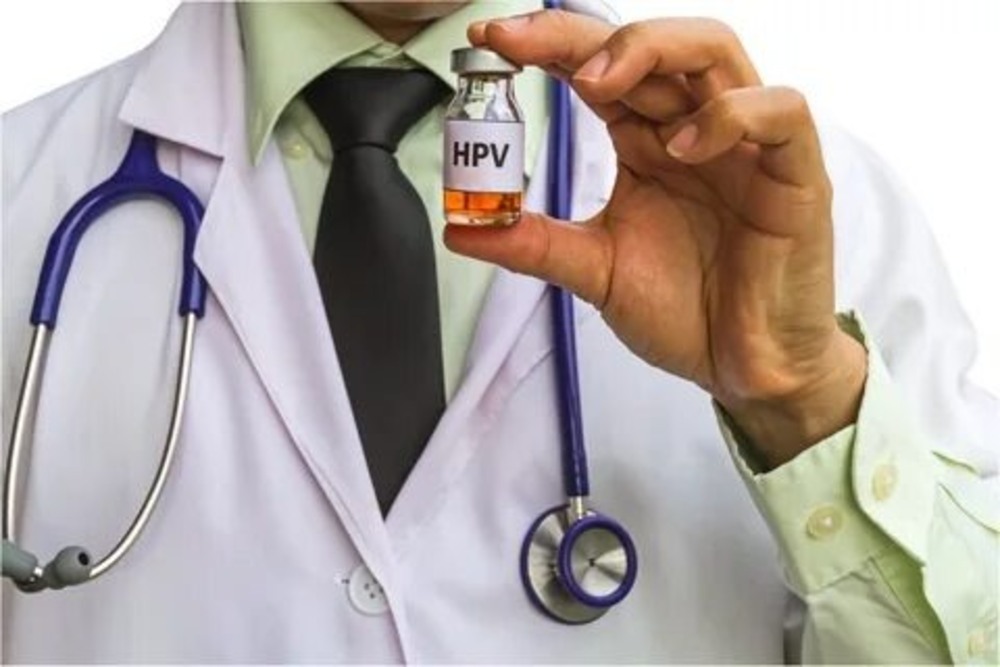 A doctor holding an HPV vaccine