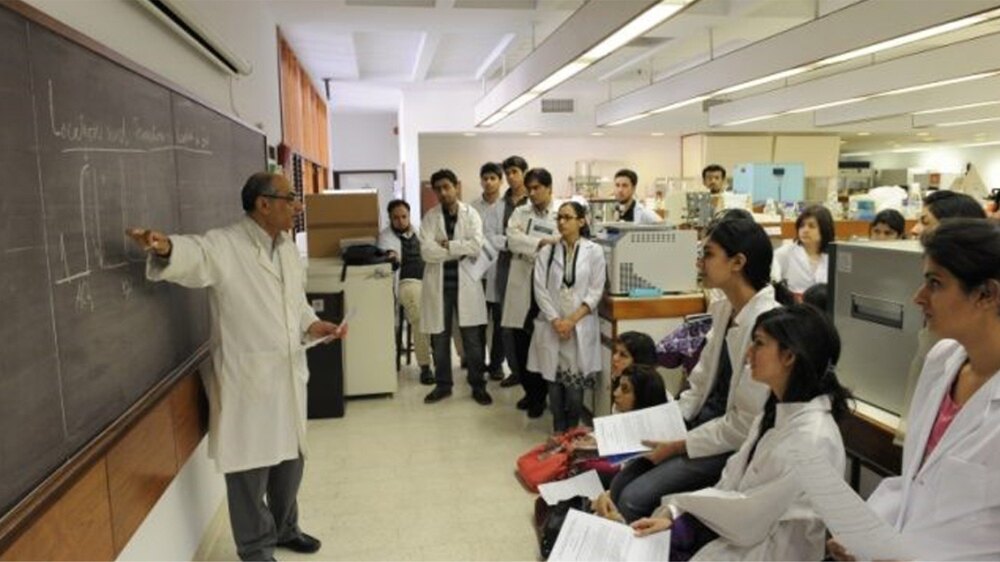 A classroom environment of a medical college with students and faculty engaged in learning.