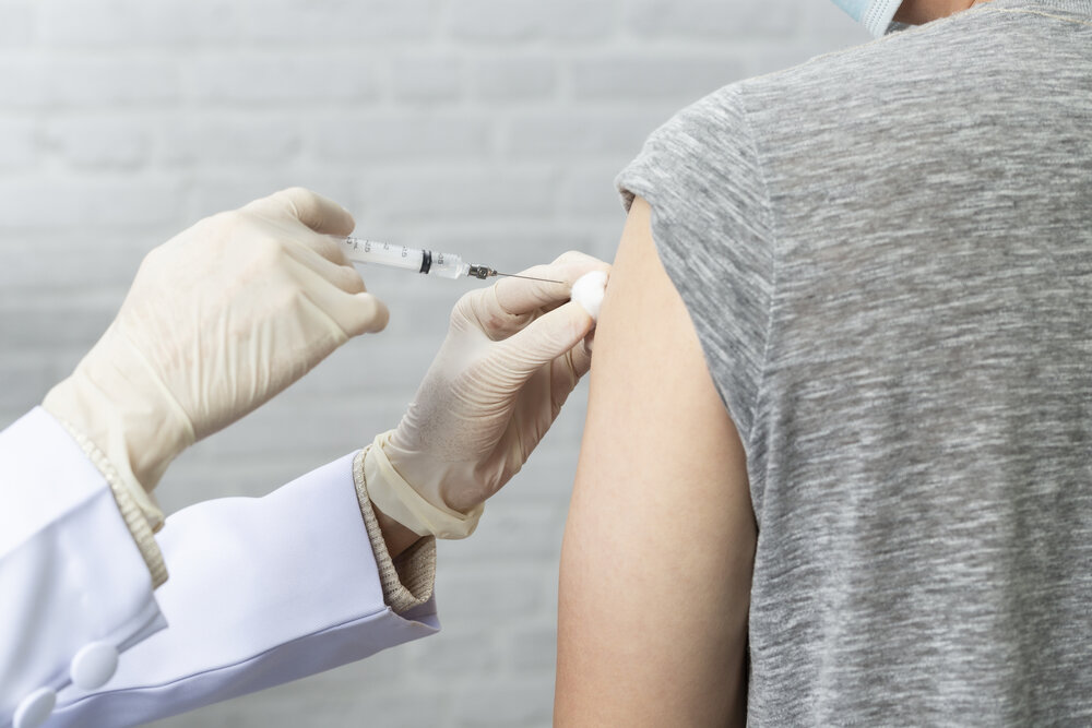 Woman receiving Depo-Provera birth control shot from healthcare professional, illustrating hormonal contraception and reproductive health care.
