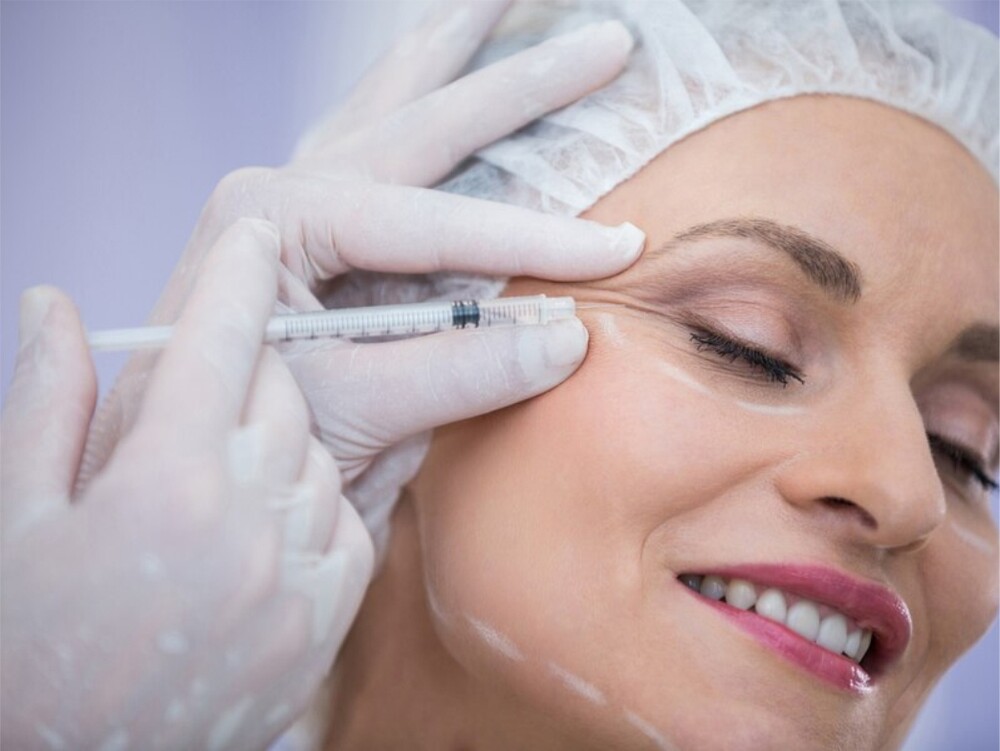 A woman receiving a Botox injection from a medical professional in a clinic