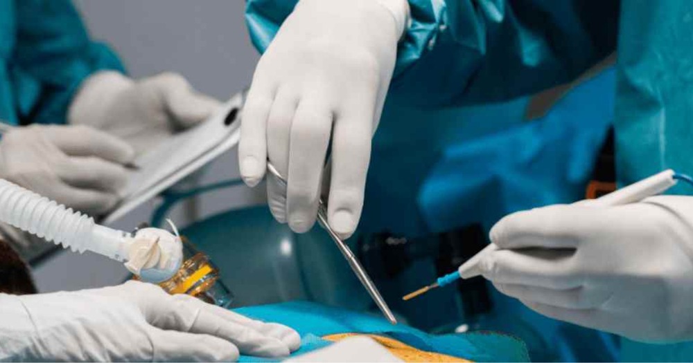Surgeons performing a kidney transplant procedure in a hospital operating room