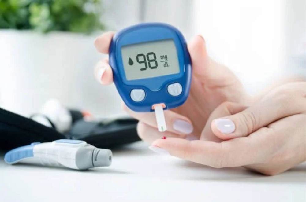 A person checking blood sugar level using a digital glucose meter