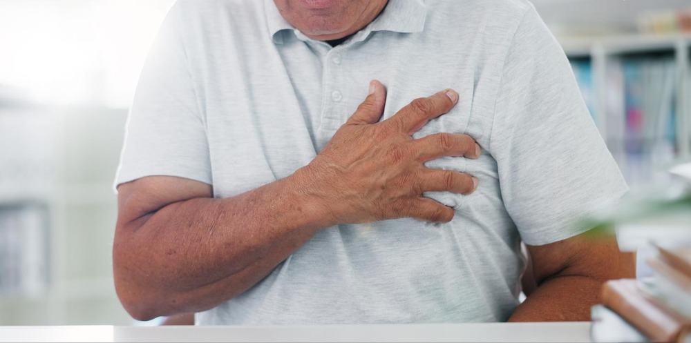 Elderly patient with chest pain, indicative of acute coronary syndrome or cardiac distress.