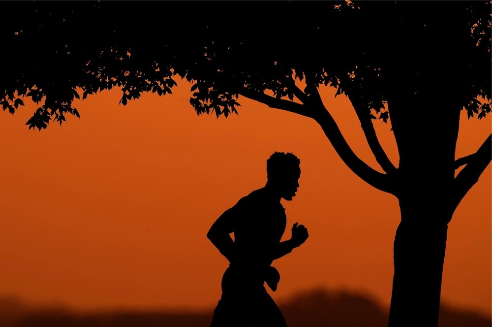 Person jogging outdoors for better physical and mental health, promoting fitness and a healthy lifestyle