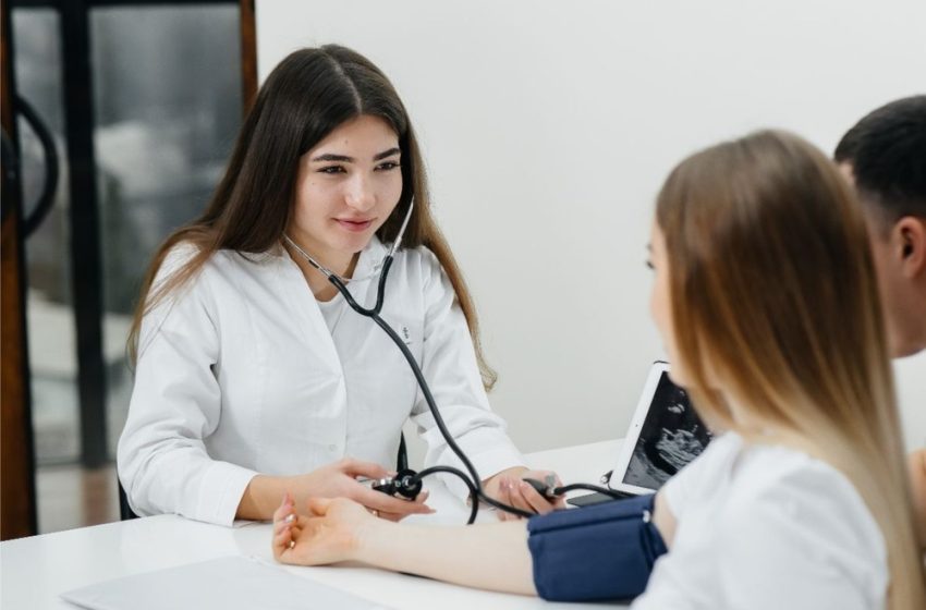 Doctor counseling a female patient in a hospital, providing professional medical guidance and healthcare advice.