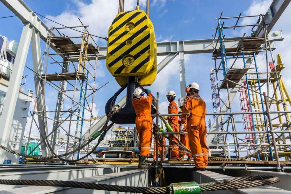 Industrial workers at a construction site in Pakistan, highlighting occupational safety and health measures and workplace environment.