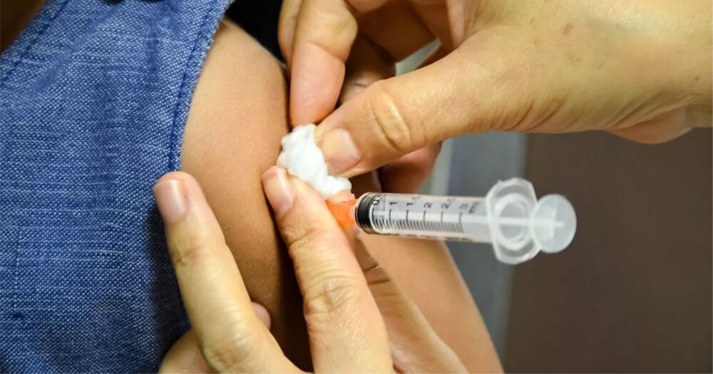 A young girl receiving HPV vaccine from a healthcare worker