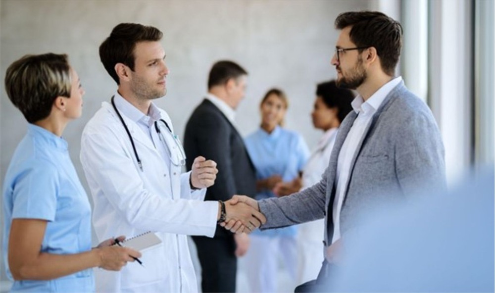 A pharmaceutical representative meeting a doctor in a public hospital