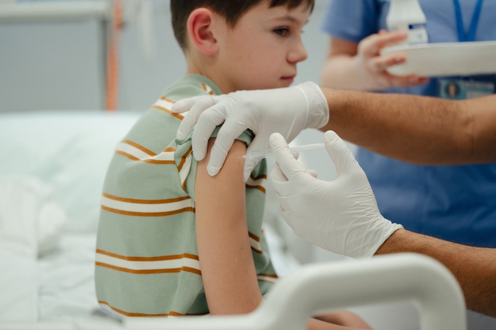 Boy receiving a vaccination shot at a clinic, child immunization, healthcare protection, pediatric vaccine safety