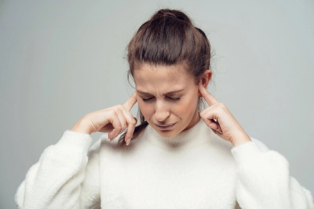 Tinnitus showing ringing, buzzing, or humming sounds in the ears, hearing disturbances, causes, diagnosis, treatment, and ear health