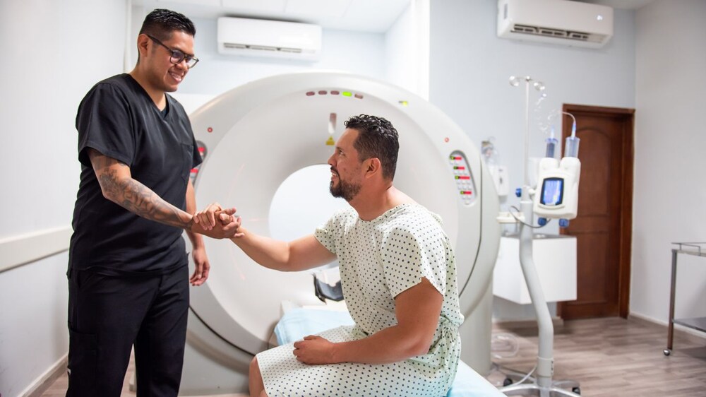 A radiologist preparing a patient for the CT scan