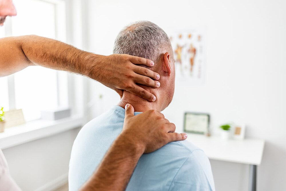 Doctor examining a patient with cervical pain and neck pain during a clinical assessment