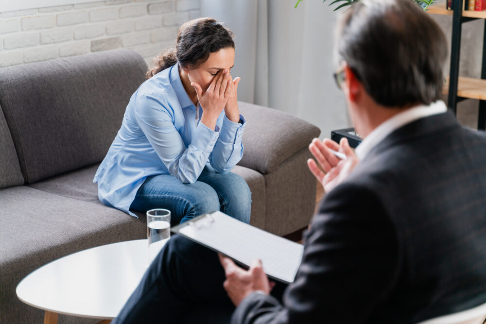 Psychologist conducting Cognitive Behavioral Therapy (CBT) session with a female patient