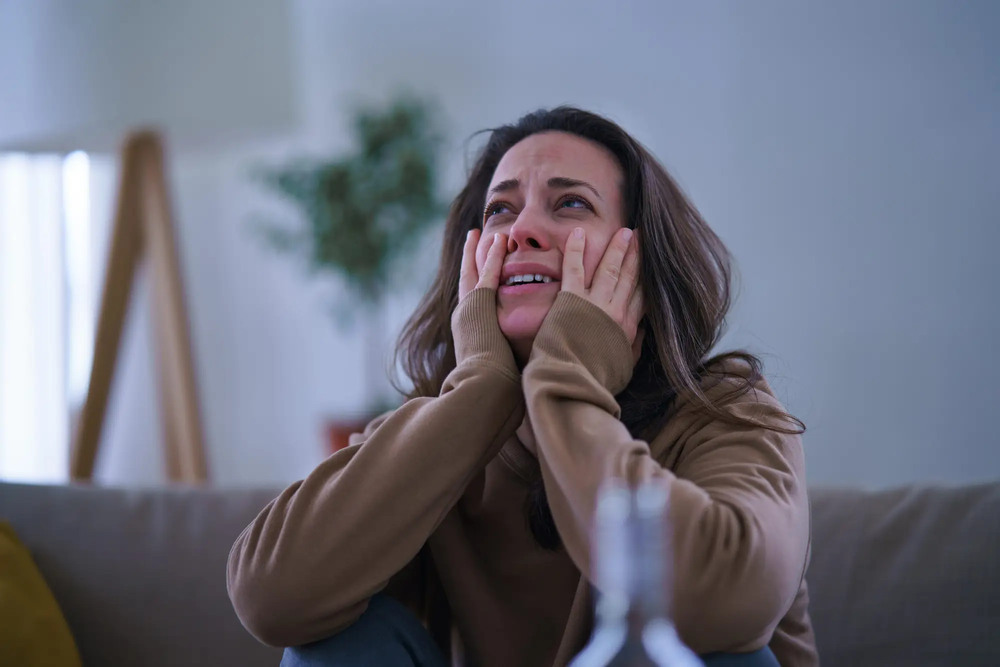 A distressed woman in emotional shock holding her chest, illustrating a common presentation of Broken Heart Syndrom